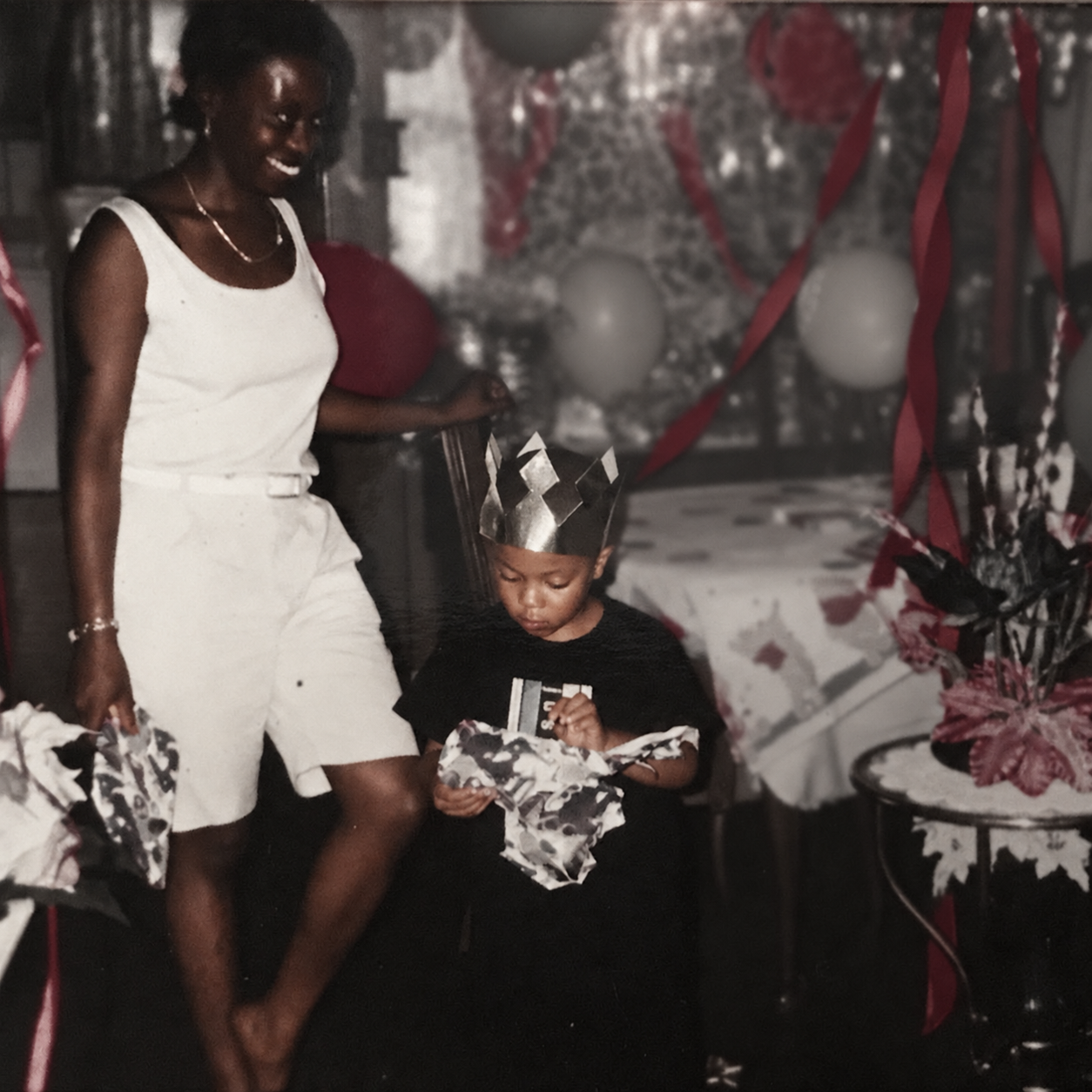 G$B Shizzy as a child with his mother at a birthday celebration